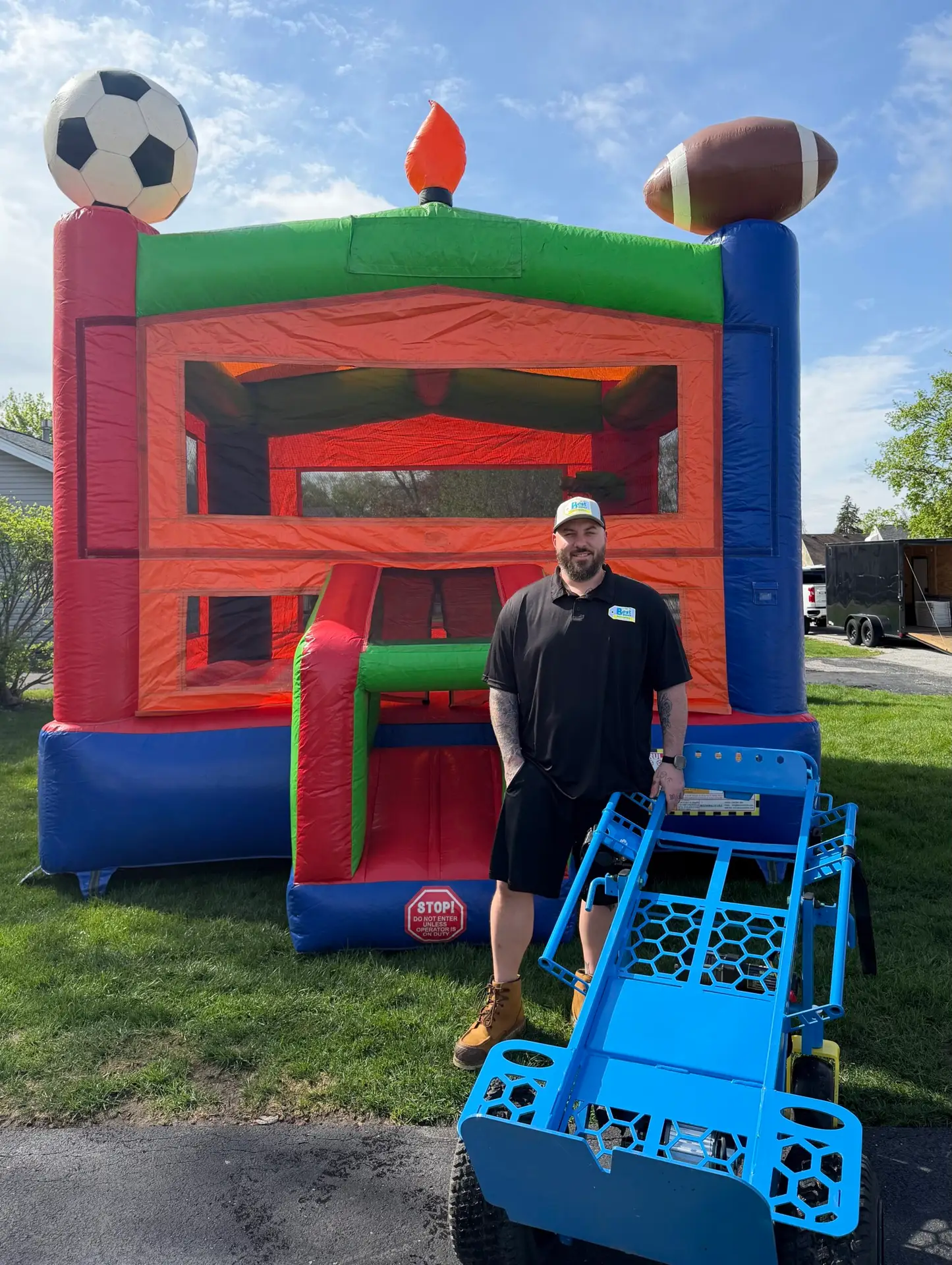 Best Bounce Party Rentals owner standing in front of clean bounce house setup with satisfaction guarantee service