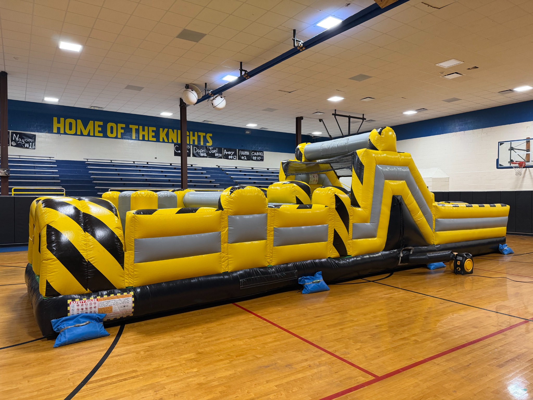 40-foot obstacle course set up inside a school gym for an indoor event